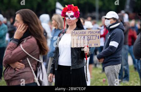 Munich, Germany. 30th May, 2020. A participant in a demonstration against the anti-Corona measures of politics stands on the Theresienwiese and holds a sign with the inscription 'Masks make fear is deadly' in her hands. Credit: Sven Hoppe/dpa/Alamy Live News Stock Photo
