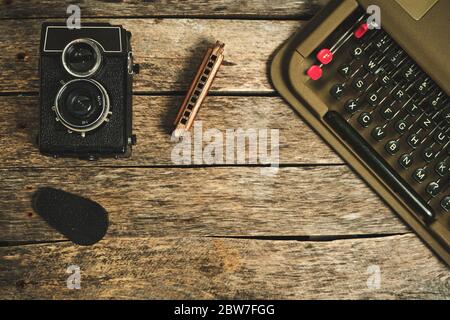Old retro typewriter, camera and typewriter on a wooden background Stock Photo