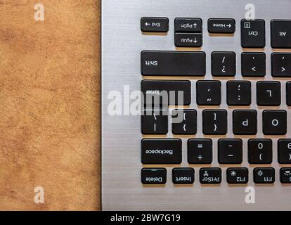 Closeup of laptop keyboard, Black keys on silver laptop. Top view with of keyboard. Stock Photo