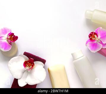 Soap, towel and hygiene product, decorated with white and lilac orchid flowers on a white background. Spa concept Stock Photo