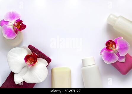 Soap, towel and hygiene product, decorated with white and lilac orchid flowers on a white background. Spa concept Stock Photo