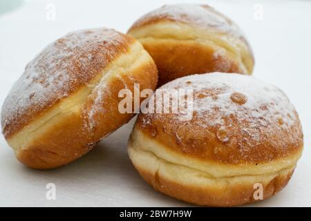 three donuts sprinkled with powdered sugar close-up Stock Photo