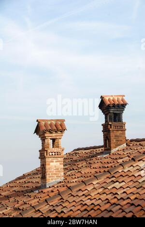 Two old chimneys on the roof with tiles Stock Photo