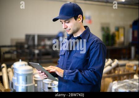 Portrait af an engineer using a tablet in a facility Stock Photo