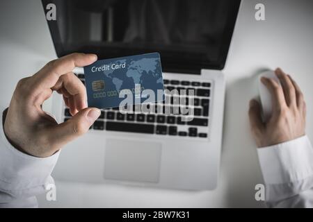 Hands holding credit card and using laptop. Online shopping Stock Photo