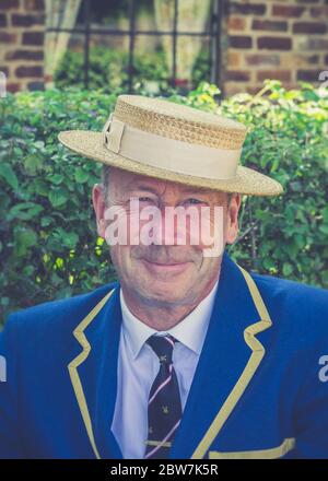 Front view close up of isolated 1940s man smiling in straw boater & school blazer, outdoors in summer at UK 1940s weekend WW2 event. Stock Photo