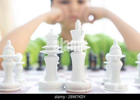 Little boy playing chess.Smart kid.Little genius Child. Intelligent gam. Stock Photo