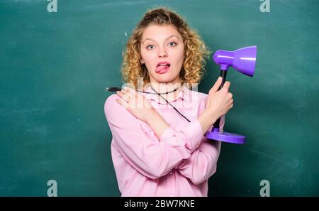 Enlightenment concept. Light up process of studying. Teacher hold table lamp chalkboard background. Insight and idea. Bright shiny idea. Creativity and inspiration. Educational idea. Knowledge day. Stock Photo