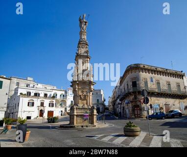 OSTUNI, APULIA, ITALY - MARCH 28th, 2018: The Saint Oronzo obelisk located at the Freedom Square is dedicated to the patron of the city:  who spared O Stock Photo
