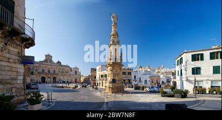 OSTUNI, APULIA, ITALY - MARCH 28th, 2018: The Saint Oronzo obelisk located at the Freedom Square is dedicated to the patron of the city:  who spared O Stock Photo
