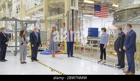 U.S. President Donald Trump views the Artemis II space capsule during a tour of the Neil Armstrong Operations and Checkout Building May 27, 2020 in Cape Canaveral, Florida. Standing left to right are: Kennedy Space Center Director Bob Cabana, Karen Pence and Vice President Mike Pence, First Lady Melania Trump, President Donald Trump, Lockheed Martin CEO Marillyn Hewson, Orion Program Manager at Lockheed Martin Space Mike Hawes, and NASA Administrator Jim Bridenstine. Stock Photo
