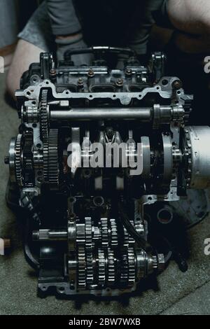 Disassembled fast motorcycle engine with visible Transmission and locking valve. Sixteen valves and four cylinder.