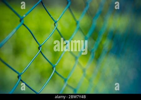 Fence with metal grid in perspective Stock Photo