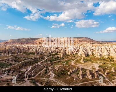 Aerial view of Goreme National Park, Tarihi Milli Parki, Turkey. The typical rock formations of Cappadocia with fairy chimneys and desert landscape Stock Photo