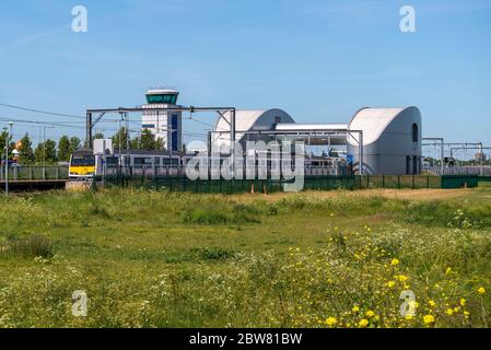 London Southend Airport railway station, with Air Traffic Control tower and British Rail Class 321 train with green field. Southend Victoria line Stock Photo