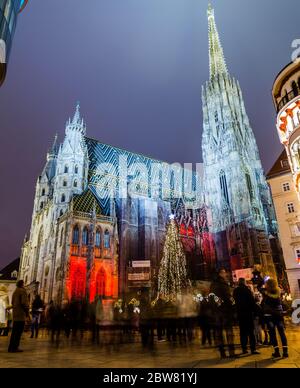 VIENNA, AUSTRIA - 20TH DECEMBER 2016: A low angle view towards Stephandsom in central Vienna during the Christmas season at night. The blur of people Stock Photo