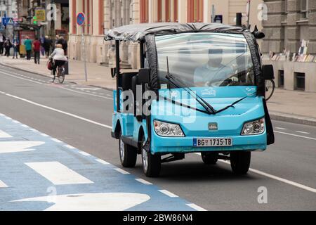 Belgrade, Serbia - May 21, 2020: Open electric vehicle '' Sparrow'' on its route on Belgrade city center streets. It covers a bit more that 2 km Stock Photo