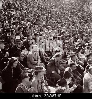 1930s CROWD OF QUIET DISHEARTENED PEOPLE MEN WOMEN SPECTATORS SITTING IN ATHLETIC STADIUM WATCHING DISAPPOINTING SPORTING EVENT  - c3581 HAR001 HARS COPY SPACE HALF-LENGTH LADIES MASS PERSONS QUIET CARING MALES ATHLETIC ENTERTAINMENT TROUBLED SPECTATORS B&W CONCERNED GATHERING SADNESS SUIT AND TIE SPORTING HEAD AND SHOULDERS HIGH ANGLE RECREATION PRIDE IN OF MOOD POLITICS SLUMPED PROFESSIONAL SPORTS CONCEPTUAL GLUM SUPPORT FOLLOWERS LOOSING DISAPPOINTING DISAPPOINTMENT DISGRUNTLED FANS MISERABLE THRONG TOGETHERNESS ATTENDANCE BLACK AND WHITE CAUCASIAN ETHNICITY HAR001 OLD FASHIONED Stock Photo