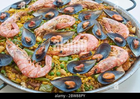 transparency cut, white background, paella typical Spanish food, with seafood vegetable meat, and rice Stock Photo