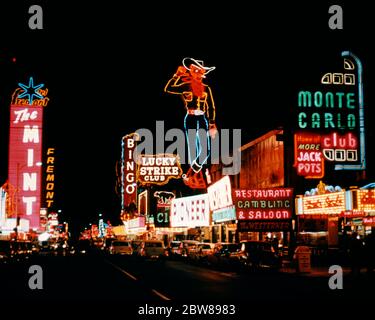 1950s COLORFUL NEON SIGNS LIGHT DOWNTOWN NIGHTLIFE ALONG FREMONT STREET LAS VEGAS NEVADA USA  - kr11229 LAN001 HARS ADVENTURE EXCITEMENT EXTERIOR OPPORTUNITY NEVADA OCCUPATIONS FREMONT GAMBLE WAGER THE MINT LAS VEGAS MONTE CARLO BET BETTING CHANCE NV OLD FASHIONED Stock Photo