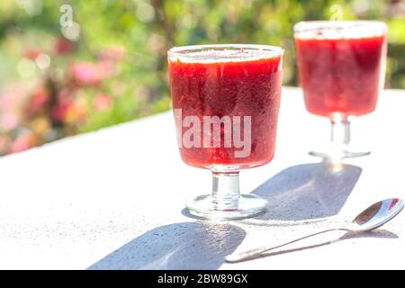 Glasses of traditional italian summer dessert strawberry granita or sorbet on nature backgraound. Berry ice cream.  Stock Photo