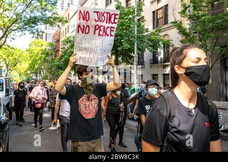 New York, USA. 30th May, 2020. Demonstrators march in New York City's Upper East Side to protest police brutality following the death of George Floyd at the hands of the Minneapolis Police. Credit: Enrique Shore/Alamy Live News Stock Photo