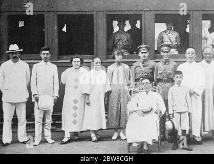 The crisis in China . An interesting picture showing the train which carried Commander in Chief Chiang Kai Shek and his staff from Canton on the expedition against Wu Pei Pu . Left to right , Micheal Borodin , Russian adviser to the Kuo Ming Yu , head of Kuomintang propaganda , Mrs Borodin , Mrs Liao Chung Kai , Mrs Chiang Kai Shek , General Gallent , Russian military adviser , and ( seated ) Chiang Kai Shek , besides whom is his son . 9 March 1927 Stock Photo