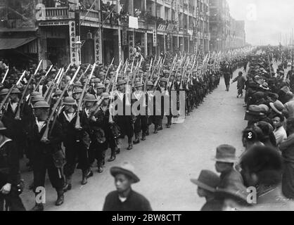 British Naval demonstration in Hong Kong . Bluejackets marching in full kit . 29 March 1927 Stock Photo