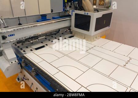 Machine tools format cutting are cut chipboard furniture in the shop. Industry Stock Photo