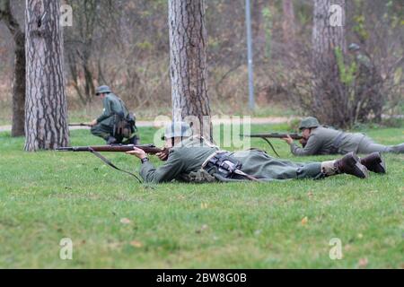 Vorzel, Ukraine - November 03, 2019: Men in the form of Wehrmacht soldiers during a battle showdown at the festival of historical reconstruction Stock Photo