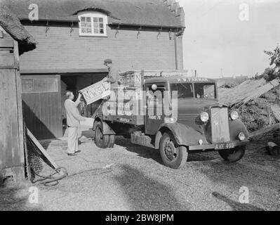 Bedford van , R W Farman . 19 August 1937 Reed Thatching in Norfolk. Mr R. W. Farman, of North Walsham, The last working representative of an old Norfolk reed thatching family. Stock Photo