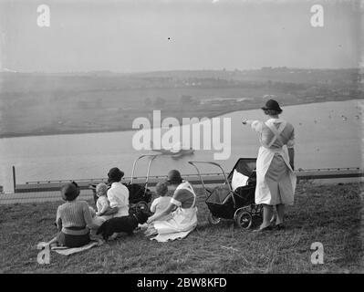 Nursemaids in Rochester , Kent , have a good view of the flying boat tests on the River Medway where the Mayo flying boats are being constructed . The flying boat in the picture is one of the the Shorts , Empire Class ,  Cambria  , arriving back after a test flight . 27 September 1937 Stock Photo