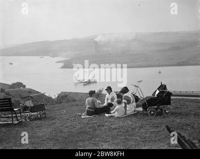 Nursemaids in Rochester , Kent , have a good view of the flying boat tests on the River Medway where the Mayo flying boats are being constructed . The flying boat in the picture is one of the the Shorts , Empire Class ,  Cambria  , arriving back after a test flight . 27 September 1937 Stock Photo