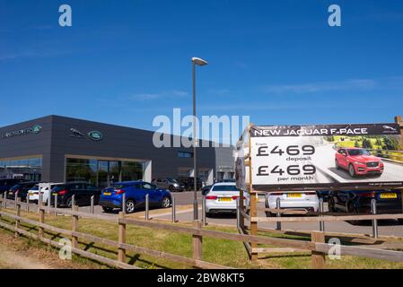 Jaguar Land Rover car dealership in Southend on Sea, Essex, UK. High end vehicle showroom. Blue sky. Tata Motors brands. Advertising hoarding. Cars Stock Photo