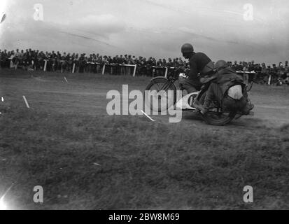 A motorbike with sidecar racing around the track . 1935 . Stock Photo