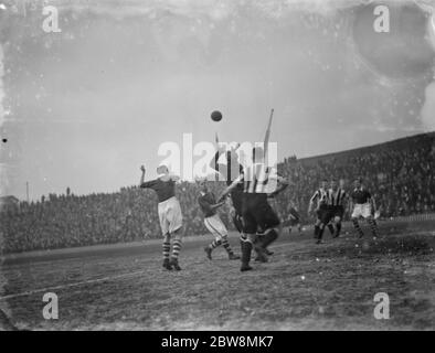 Millwall football club versus Notts County Football Club . A goal keeper competes for the ball . 1936 Stock Photo