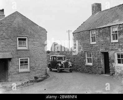 A car negotiates the tight turns in St Ives . 1936 . Stock Photo
