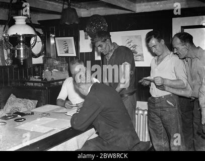 Pay day for the crew of the tramp steamer the ' SS Eston ' . 1935 Stock Photo