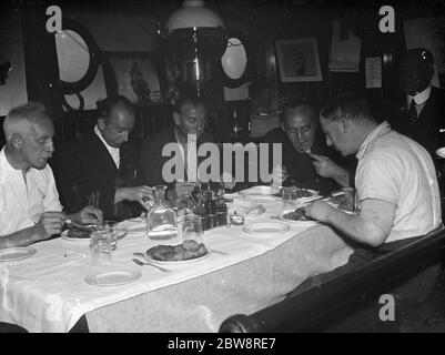 Some of the crew of the tramp steamer , the ' SS Eston ' eating dinner in the ship ' s mess . 1935 Stock Photo