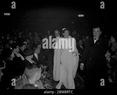 Celebrities , Jessie Matthews with her husband , Sonnie Hale walk through the audience as they open the new Granada cinema at Welling in Kent . 1938 Stock Photo