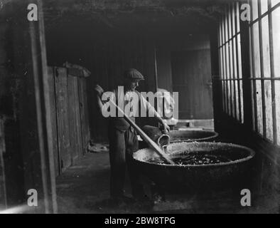 An example of primitive manufacturing methods in the 1930s, a man pours ...