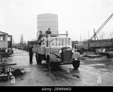 Bedford lorries belonging to Le Grand Sutcliff and Gell Ltd from Southall Londond , loading up at a freight station . 1936 . Stock Photo