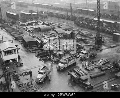 Bedford lorries belonging to Le Grand Sutcliff and Gell Ltd from Southall Londond , loading up at a freight station . 1936 . Stock Photo