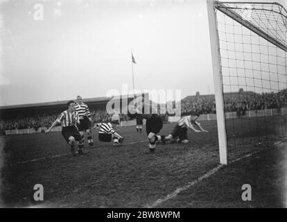 Dartford versus Darlington football match . Action in front of the goal , the goalkeeper makes a save . 1937 Stock Photo