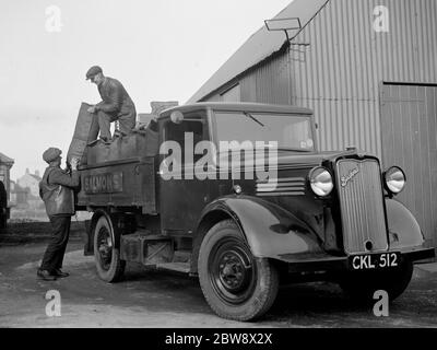 One of the delivery lorries from H Salmon , Coal and Coke Merchants , in Orpington , Kent being loaded with sacks of coal . 1936 . Stock Photo