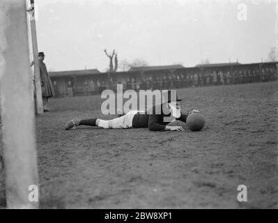 The Woolwich Metropolitan Police Football Club take partin in a novelty football match . 1939 Stock Photo