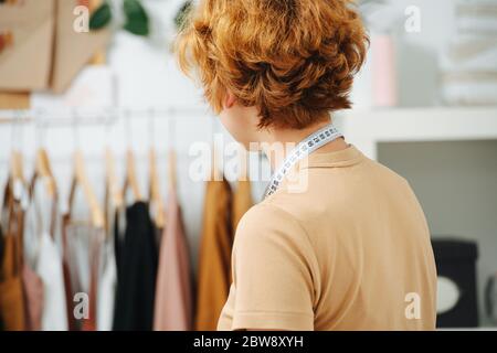 Girl tailor with measuring tape around her neck Stock Photo