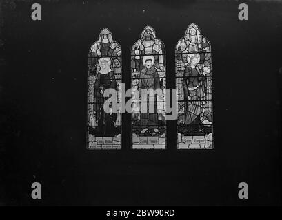 Stain glass windows at the Holy Trinity church in Eltham , London . The three saints depicted are left to right : Saint Hilda , Saint Francis and Saint Margaret . 4 February 1939 Stock Photo