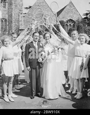 The wedding of Mr W A Hobcraft and Miss Joan Shuter . The bride and groom walking out through a tunne of tennis rackets . 4 June 1939 Stock Photo