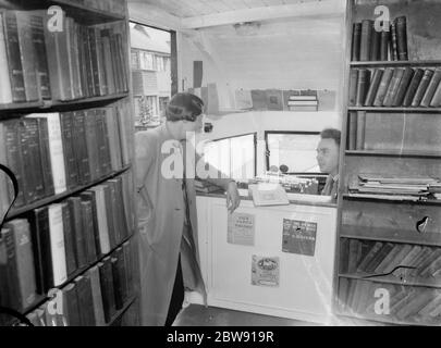 A woman visiting the Kent County mobile library . 1939 Stock Photo